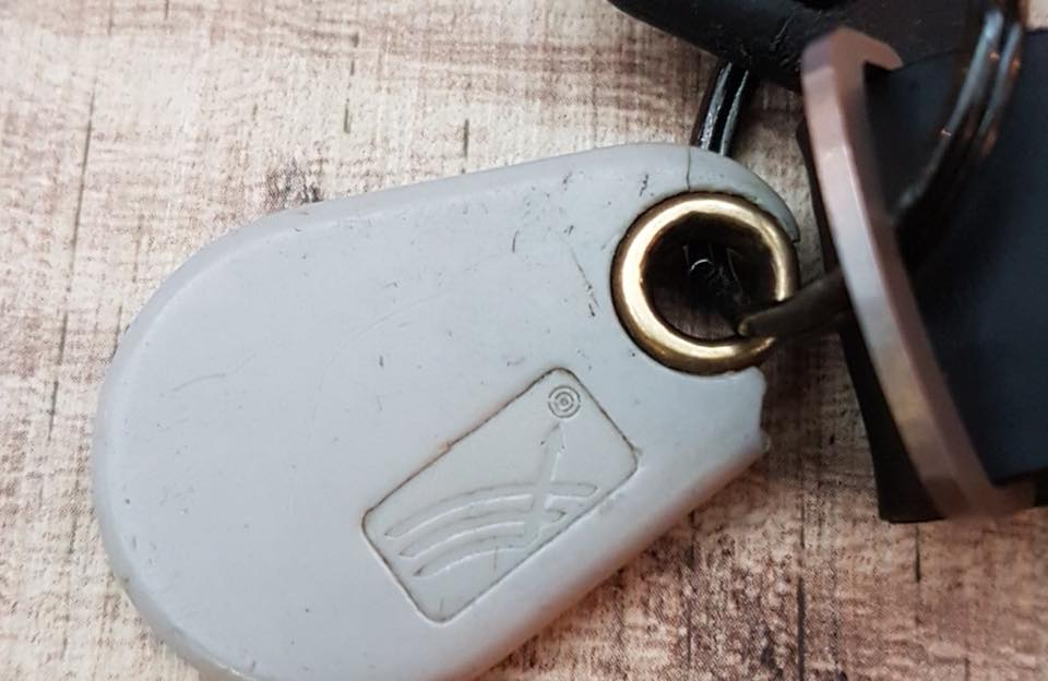 Close-up of a KERI keyfob showing the engraved number, perfect for secure duplication services